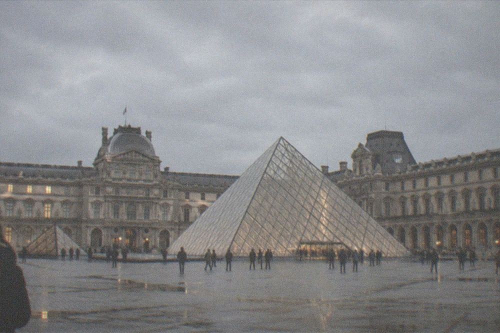 The glass Pyramid entrance of the Louvre seen from the courtyard at dusk