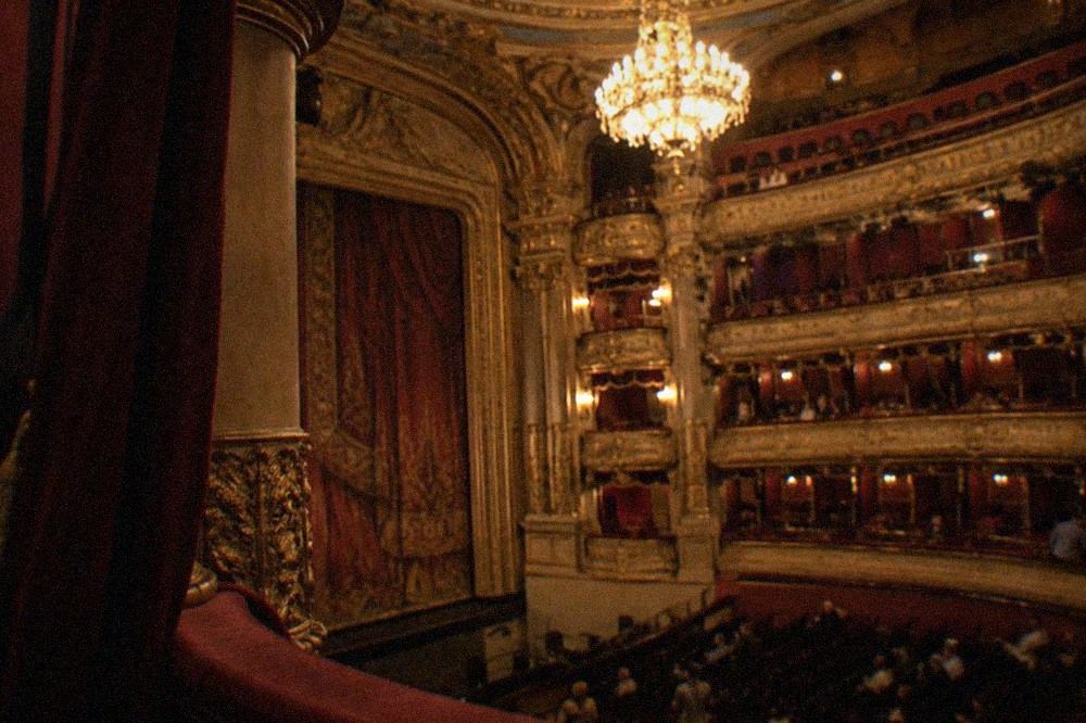 The red and gold auditorium of the Palais Garnier with its chandelier