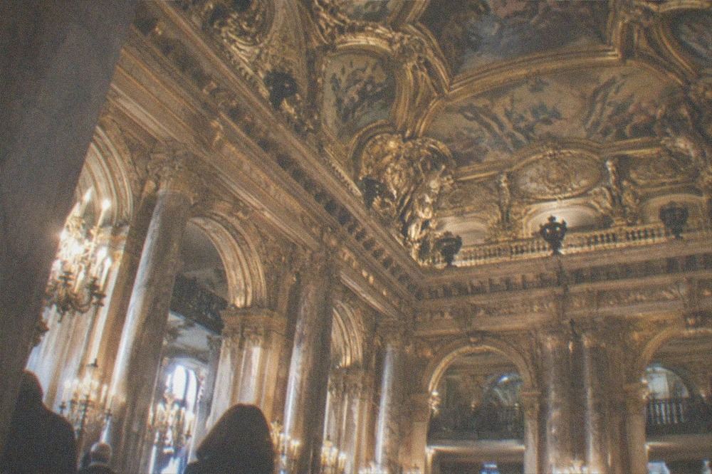 The painted ceiling and gilded gallery above the main foyer of the Palais Garnier