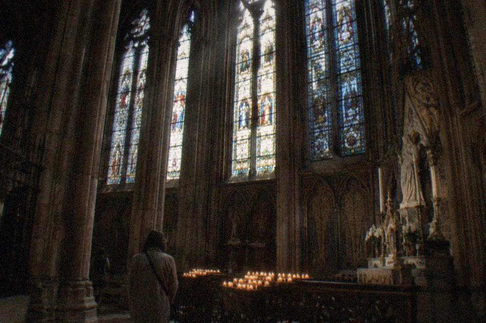 Gothic stained glass window wall inside a medieval chapel