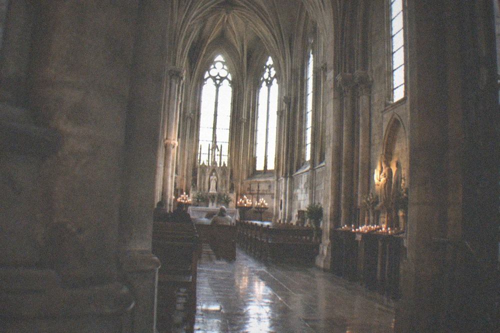 Gothic chapel interior with tall arched windows and stone vaulting