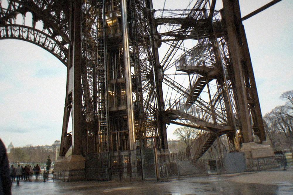 The lifts and stairwells of the Eiffel Tower seen from beneath the ironwork