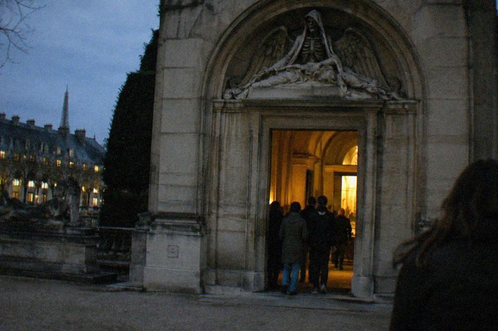 Stone archway inscribed with the warning that you are entering the empire of death