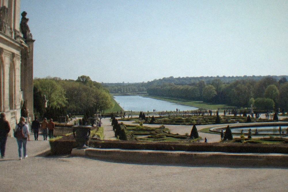 The formal gardens with the Grand Canal stretching toward the horizon and manicured parterres in the foreground