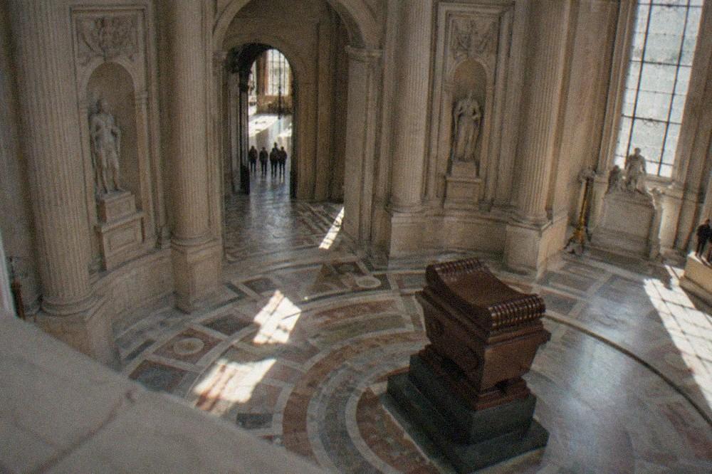 The interior of the Dôme des Invalides seen from the upper gallery, with sunlight falling on the marble floor