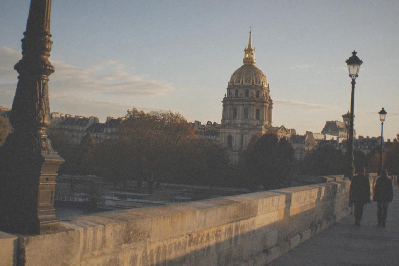 The golden dome of Les Invalides rising above the Paris rooftops in late afternoon light