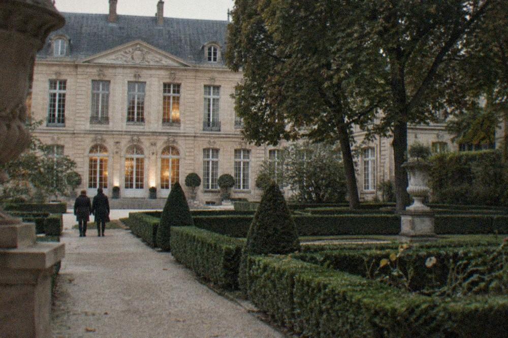 Bronze sculptures standing among trimmed hedges in the Musée Rodin garden