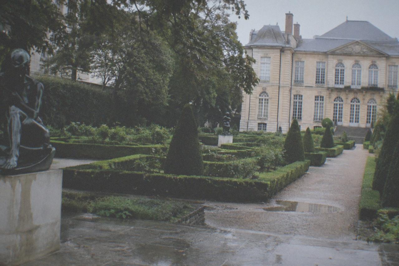 The sculpture garden of the Musée Rodin beside the Hôtel Biron mansion, with hedges, gravel paths and bronze statues