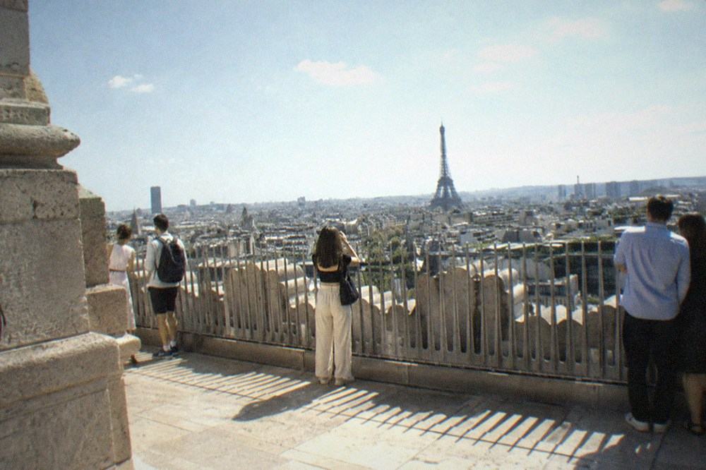 The rooftop terrace of the Arc de Triomphe with the Eiffel Tower and Paris rooftops in the distance