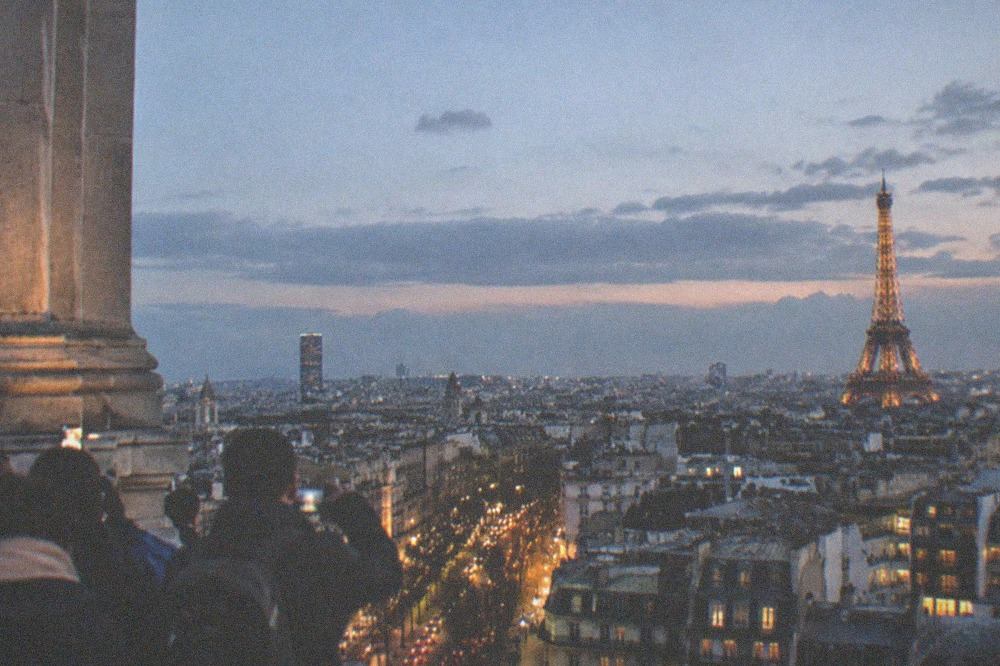 The Eiffel Tower and the Paris skyline photographed from the Arc de Triomphe terrace at dusk