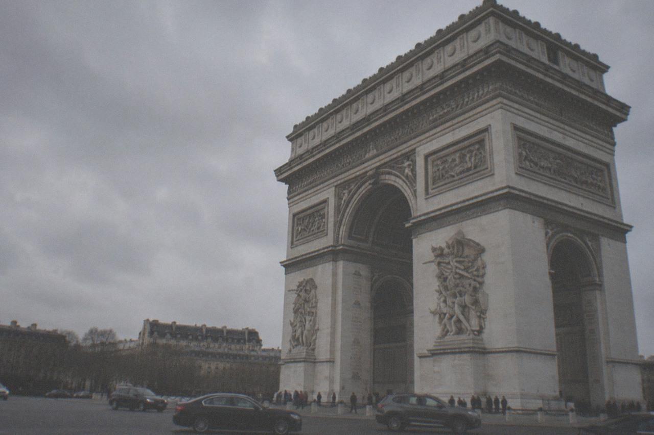 The Arc de Triomphe seen from below with the Paris rooftops stretching behind it