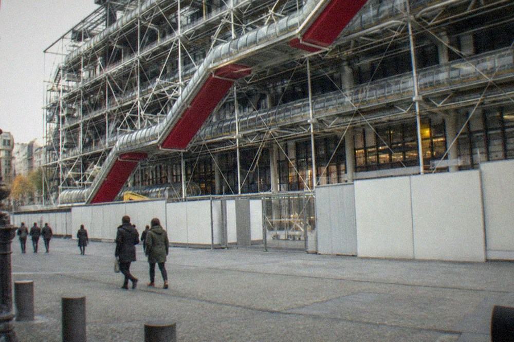 Construction hoardings covering the entrance to the Centre Pompidou on a Paris street