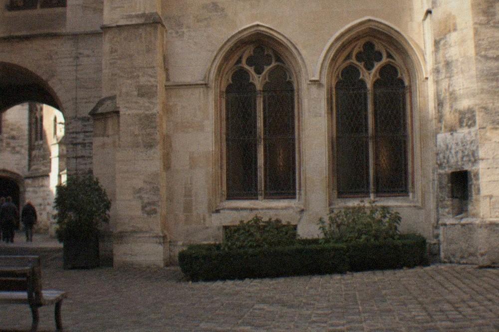 The stone courtyard and twin arched windows of the Hotel de Cluny in Paris
