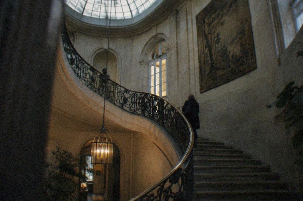 Spiral stone staircase inside the Hotel Sale rising toward a skylight