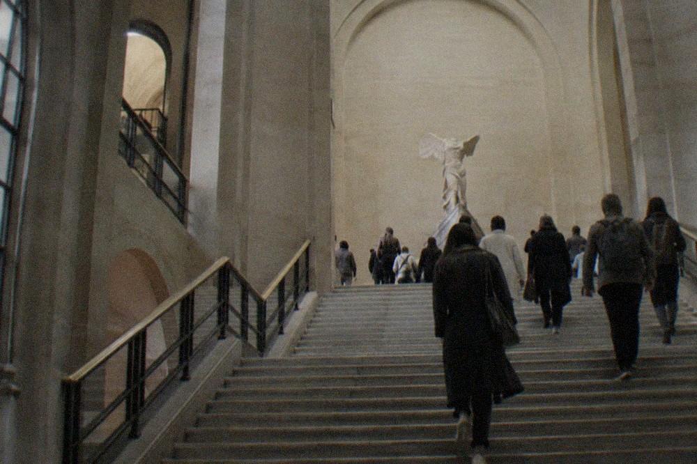 The Daru staircase inside the Louvre rising toward the Winged Victory of Samothrace