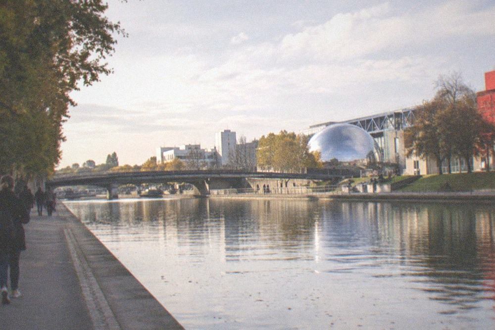View along the Canal de l'Ourcq toward modern buildings of the Parc de la Villette