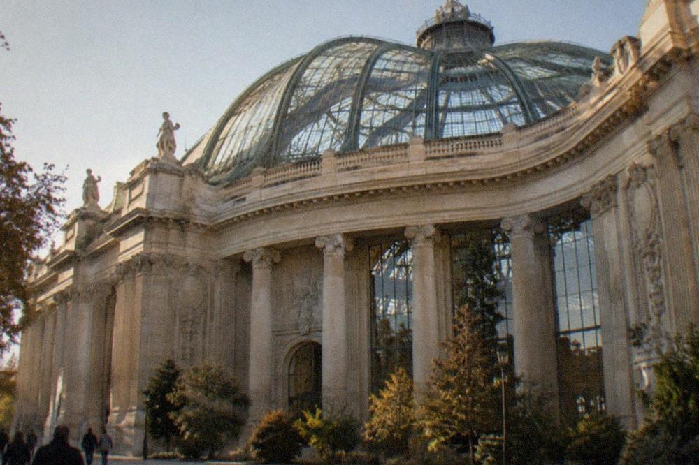 The glass nave of the Grand Palais roof seen from below, with ironwork radiating from the central dome