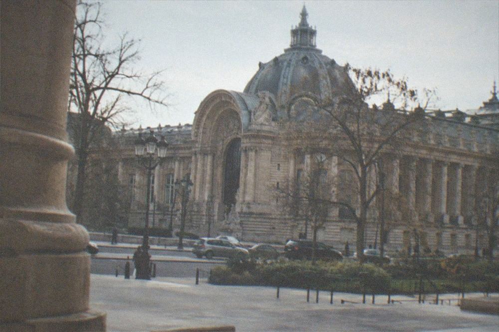 The stone facade and columns of the Petit Palais seen across the Avenue Winston Churchill from the Grand Palais