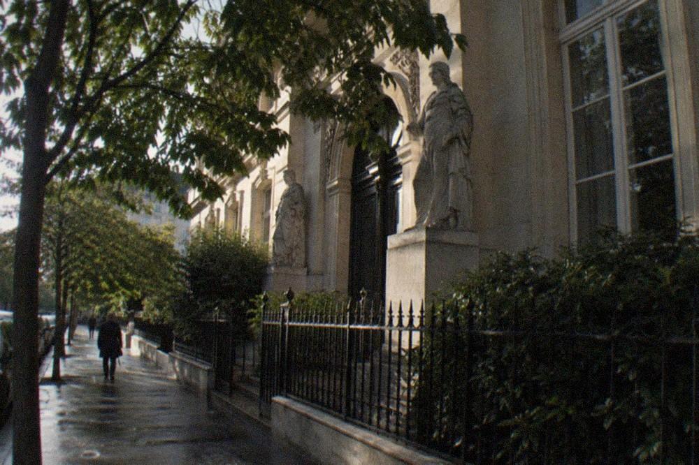 Sunlight falling on the facade of a small museum on a quiet Paris street
