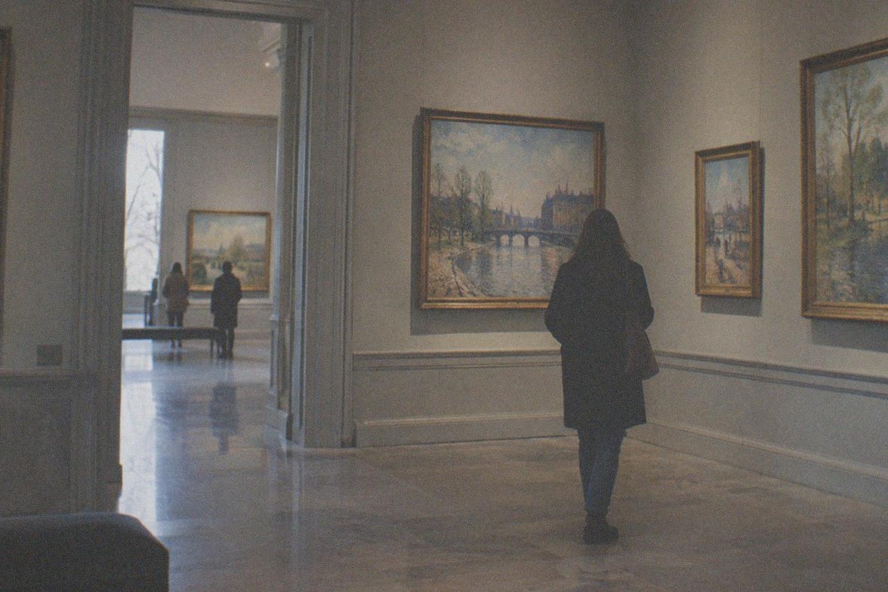 A softly lit gallery wall hung with Impressionist canvases in a small Paris museum