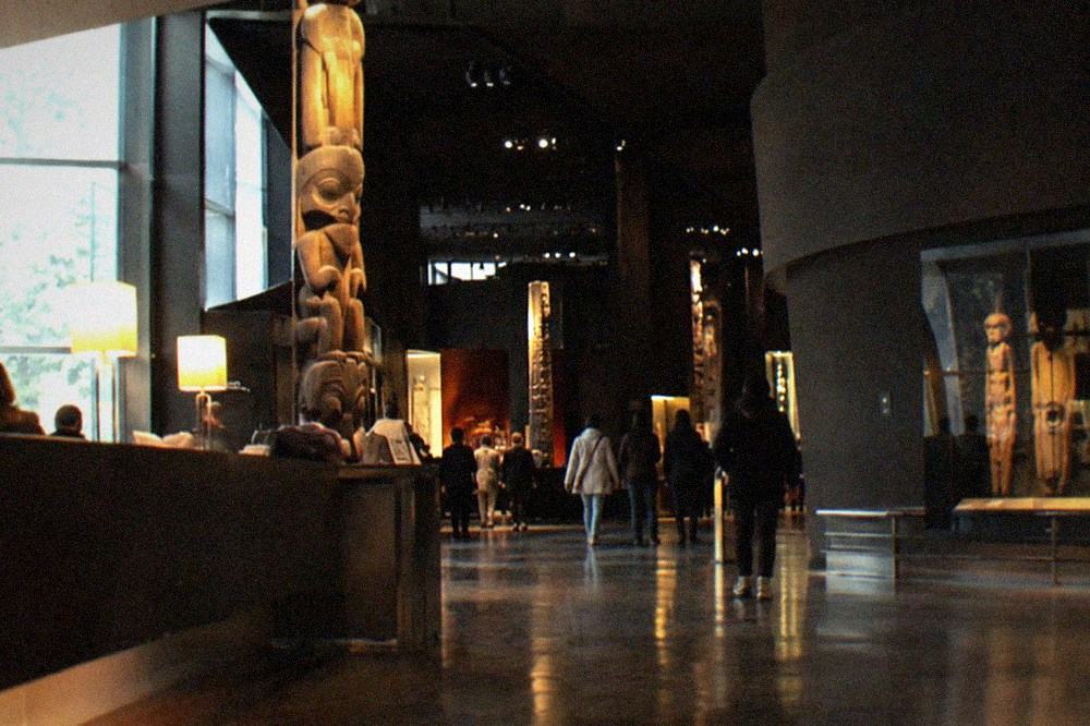 The museum ticket desk and entrance hall of the Musee du quai Branly with its dark interior walkway