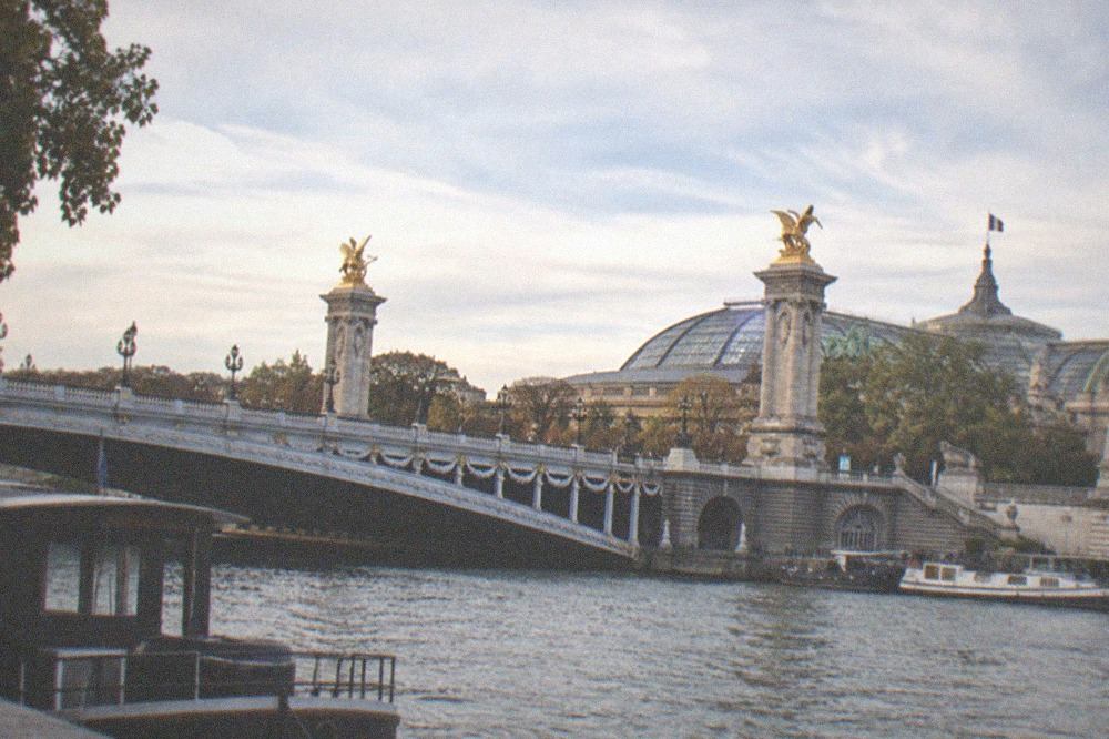The gilded Pont Alexandre III over the Seine with the Petit Palais behind it