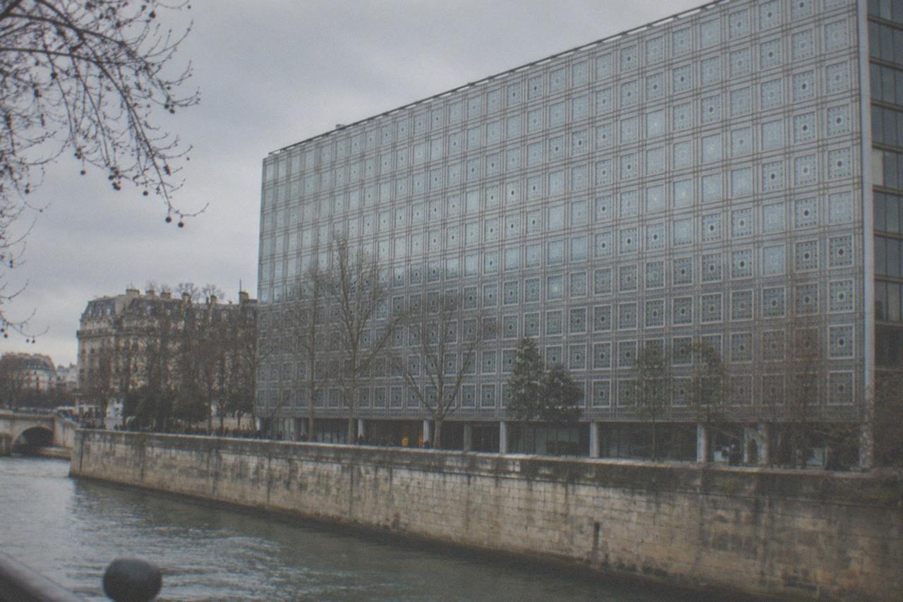 The south facade of the Institut du Monde Arabe with its grid of metal screens rising above the Seine