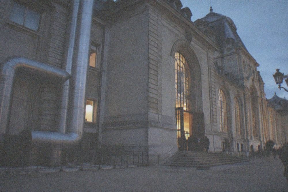 A pipe and duct structure on the outside of a large museum building