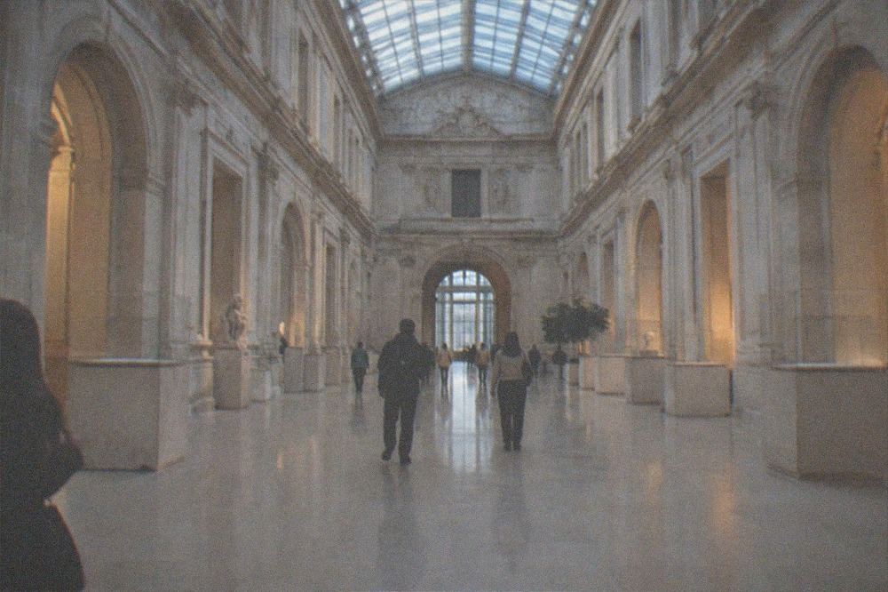 Sculpture gallery with marble figures under a glass ceiling