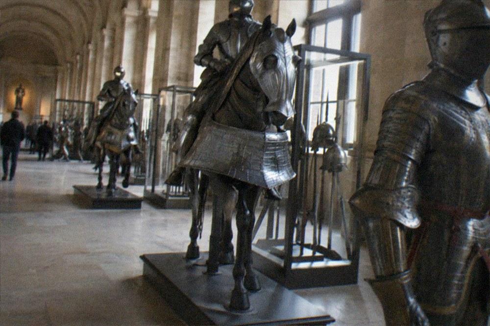 Armour displays in a stone-vaulted military museum hall