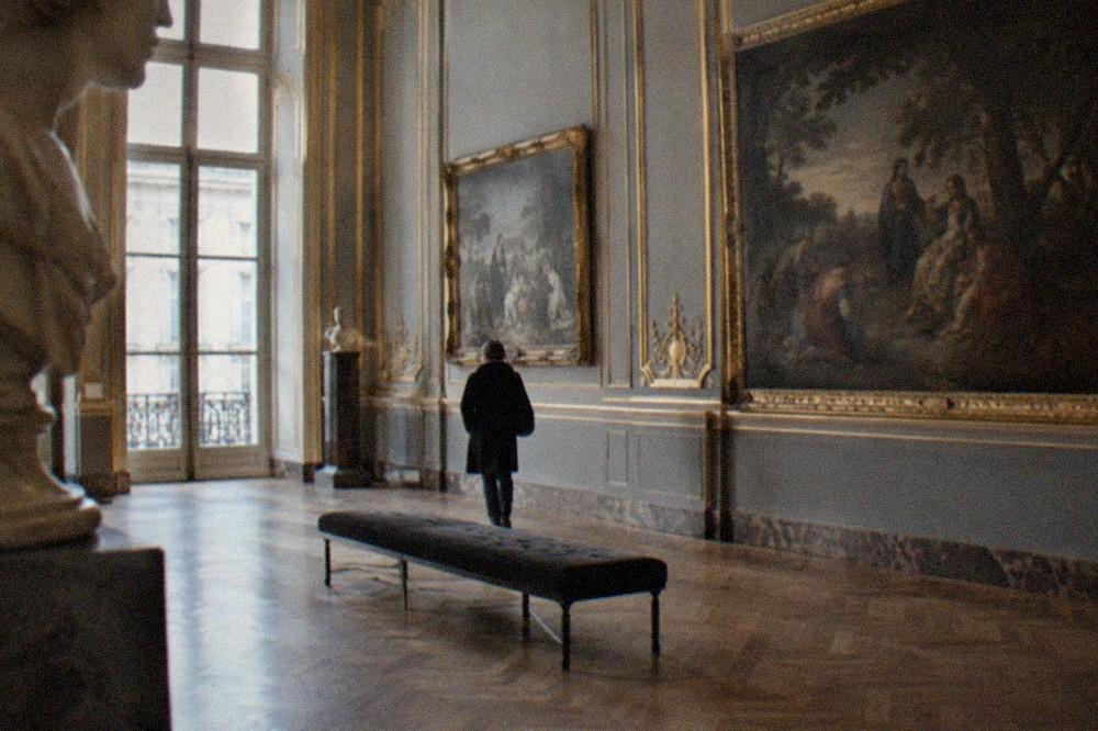 Museum galleries in Paris with paintings hung on ornate walls