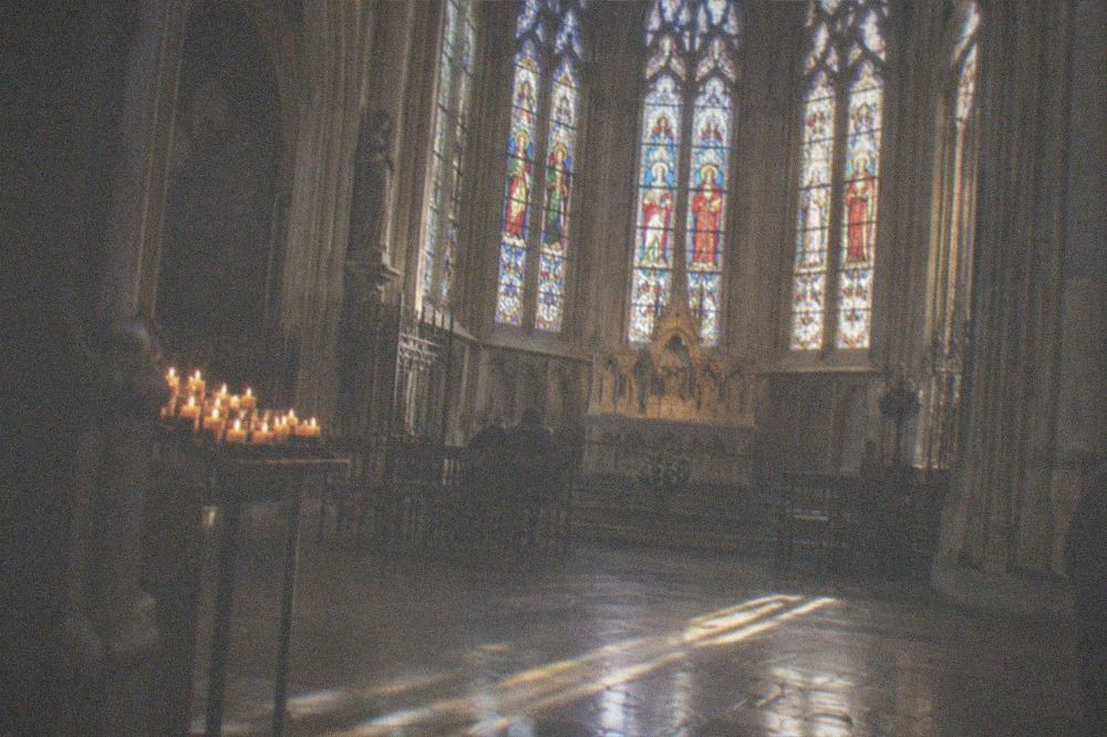 Gothic stained glass window glowing in a Paris chapel