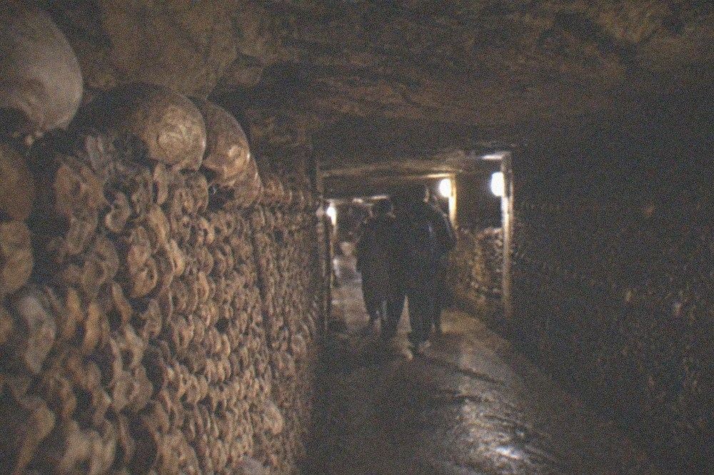 Underground tunnel lined with stacked stone in the Paris Catacombes