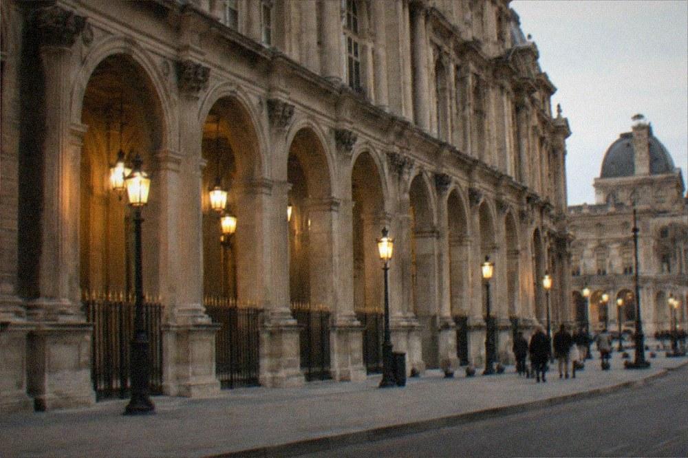 Historic stone facade of a Paris museum seen from a quiet street