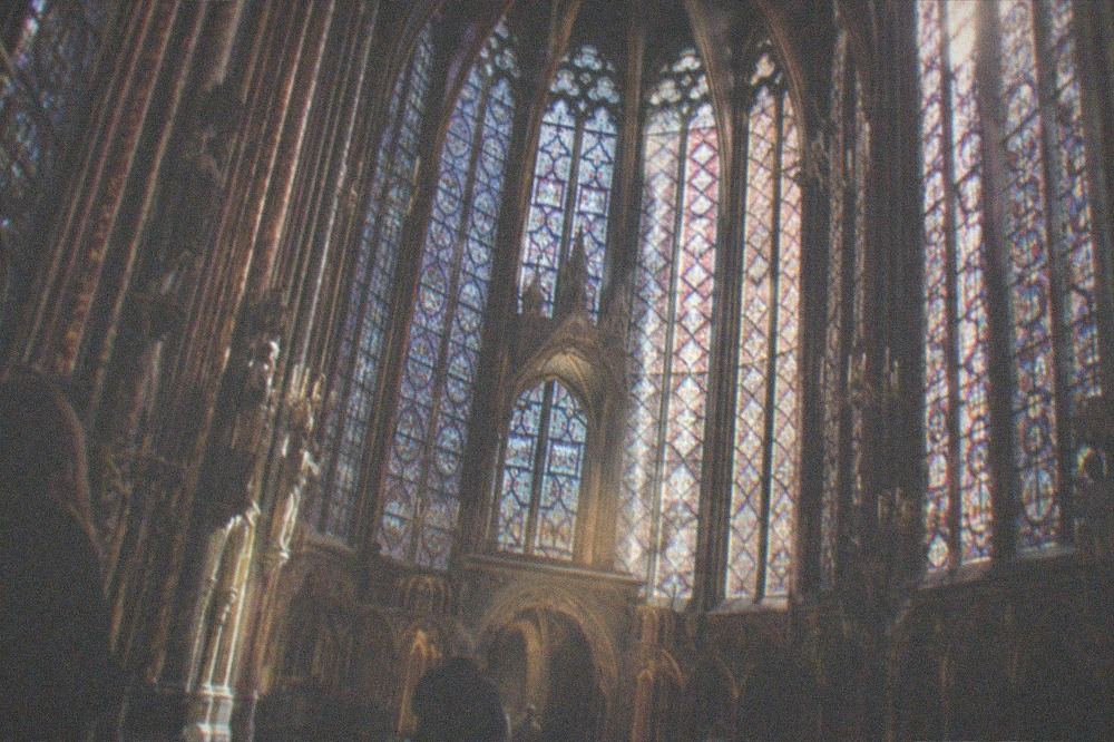 The Sainte-Chapelle upper chapel glowing with stained glass windows on all sides