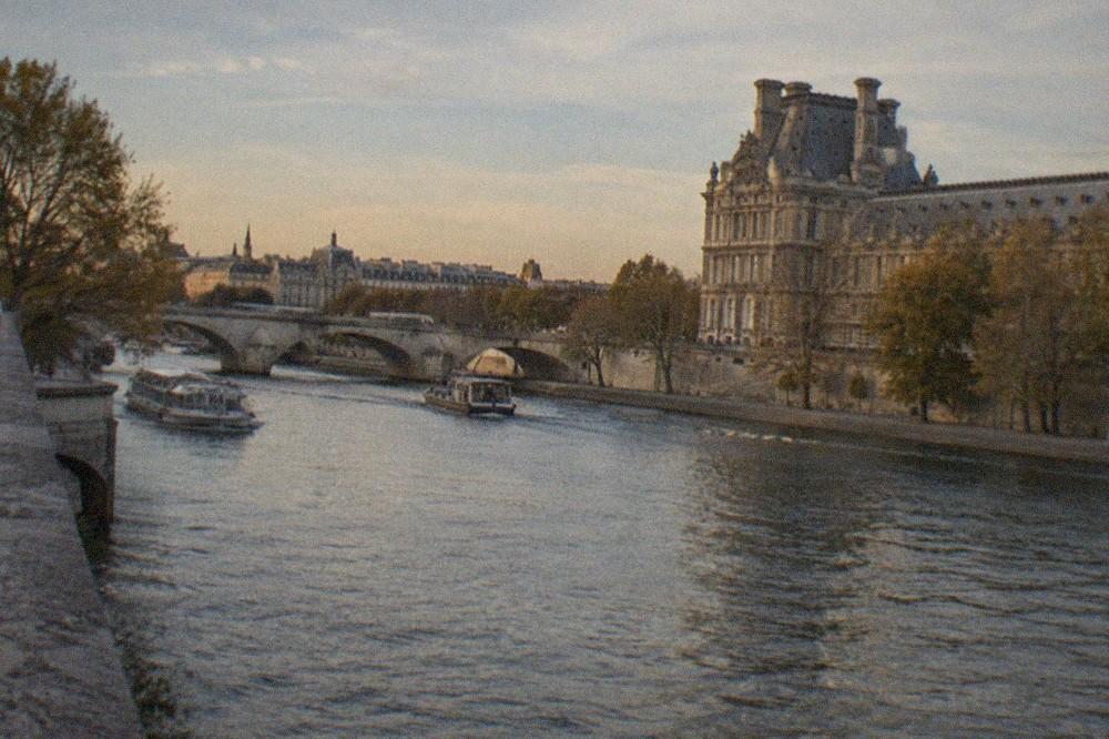 The Seine at golden hour with the Louvre on the right bank and the Left Bank quays beyond