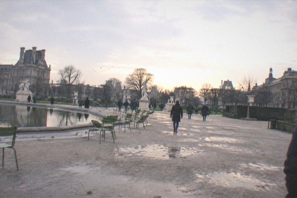 The formal gravel paths of the Tuileries garden stretching between two grand museum buildings
