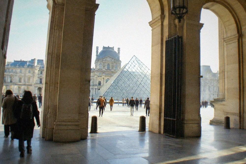 The interior courtyard of the Louvre with the glass pyramid in daylight
