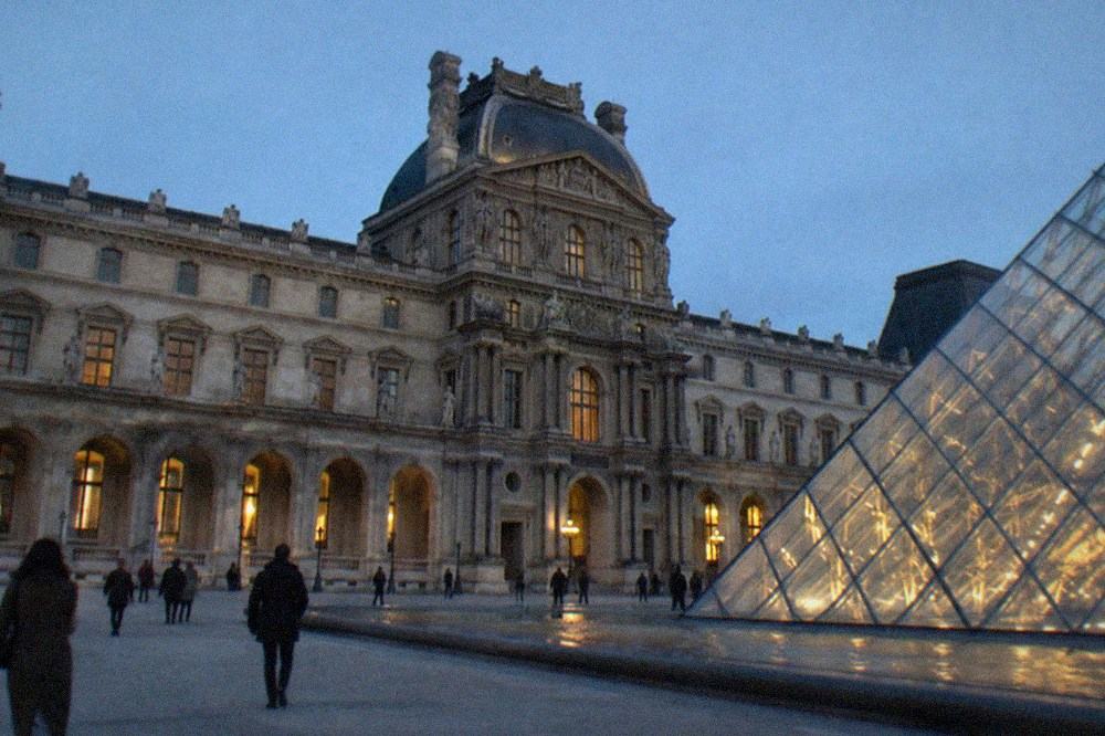 Historic Paris monument exterior with ornate stonework under a clear sky