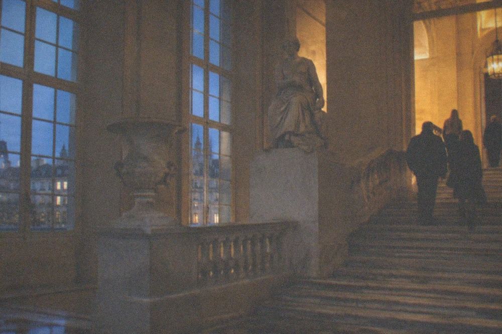 A quiet free museum interior with a marble staircase and tall windows