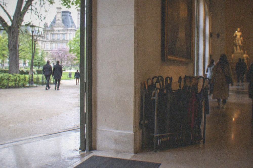 A museum corridor with visitors' umbrellas drying by the cloakroom