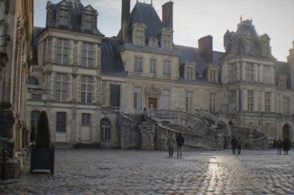 The horseshoe staircase and courtyard of the Château de Fontainebleau on a quiet afternoon