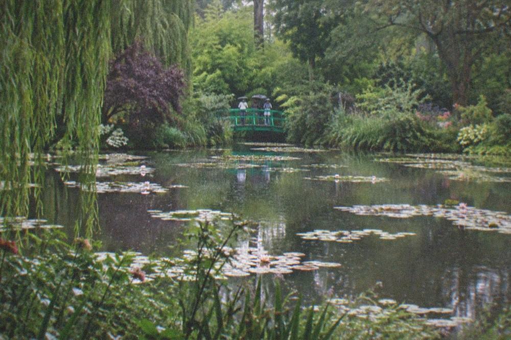 The water garden with the green Japanese bridge and water lilies at Claude Monet's Giverny